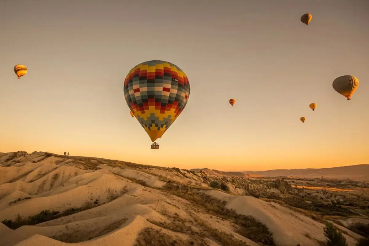 Hot air balloons over Cappadocia fairy chimneys in Turkey - affordable adventure travel destination